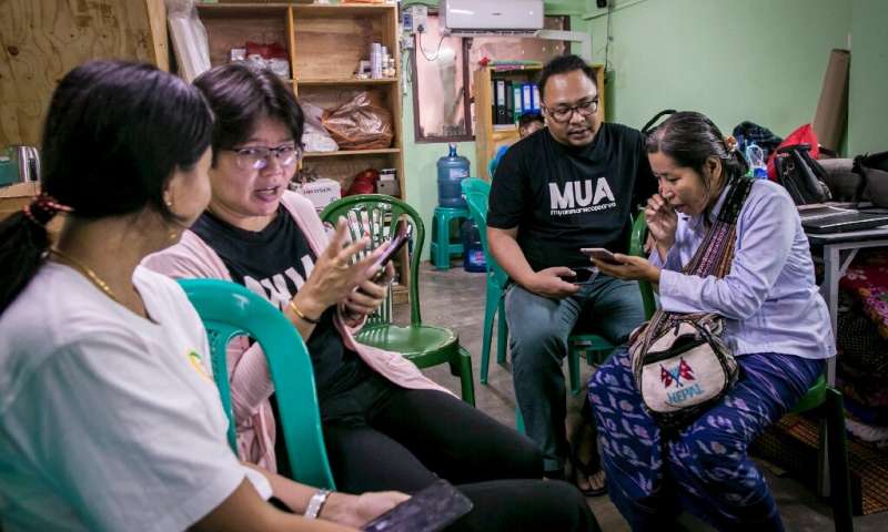 Volunteers in Yangon help phone users switch from the old Zawgi font to unicode