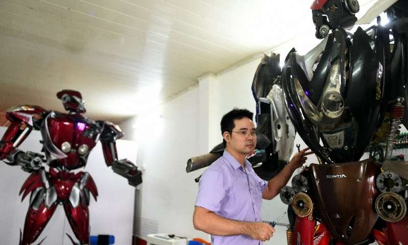 Robot One (L) is just the first of many, the engineers say, with dreams of creating a robot park in Hanoi one day